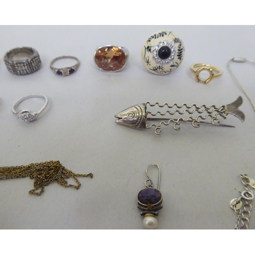 76 - Silver, white metal and other items of personal ornament: to include a fish design brooch; and dress... 