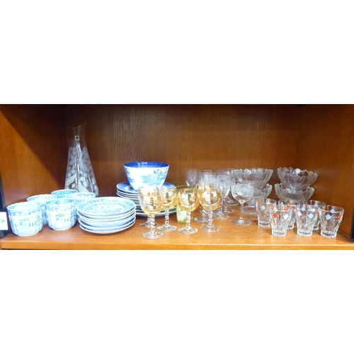 80 - Ceramics and glassware: to include blue and white china tableware, decorated in a version of the Wil... 