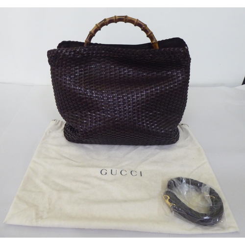 88 - A Gucci chocolate brown woven hide tote bag  no.001-2404-1577 with a bamboo handle, shoulder st... 