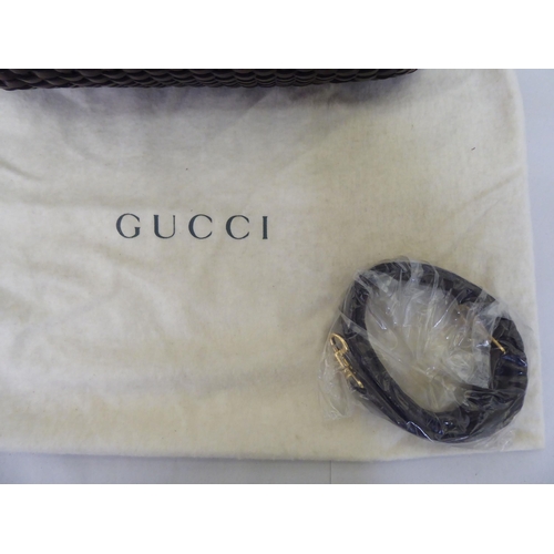 88 - A Gucci chocolate brown woven hide tote bag  no.001-2404-1577 with a bamboo handle, shoulder st... 