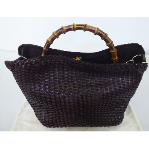 88 - A Gucci chocolate brown woven hide tote bag  no.001-2404-1577 with a bamboo handle, shoulder st... 