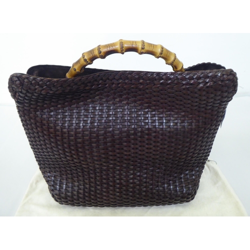 88 - A Gucci chocolate brown woven hide tote bag  no.001-2404-1577 with a bamboo handle, shoulder st... 