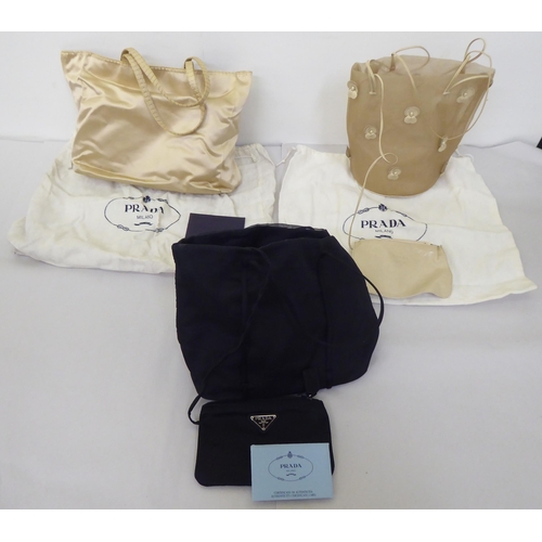 90 - Three Prada fabric handbags, viz. a Raso Gold 1998 with dust cover, one in cream coloured net with p... 