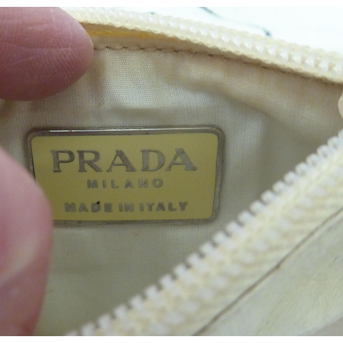 90 - Three Prada fabric handbags, viz. a Raso Gold 1998 with dust cover, one in cream coloured net with p... 