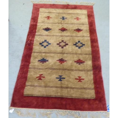 94 - A red and brown patterned silk rug  34