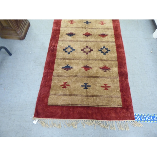 94 - A red and brown patterned silk rug  34