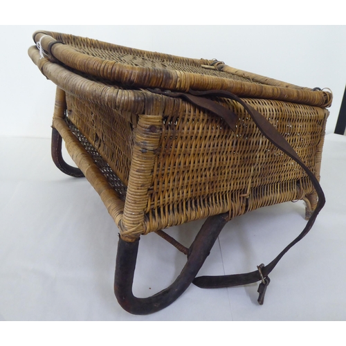 97 - A late Victorian/Edwardian woven split cane folding campaign/anglers chair with a storage compartmen... 