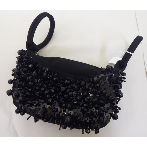 98 - A Lulu Guinness black and bead ornamented handbag with loop handles and dust cover