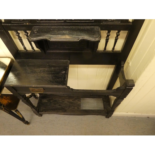 99 - A late Victorian black stained and carved oak hallstand, incorporating a bevelled mirror and an offs... 