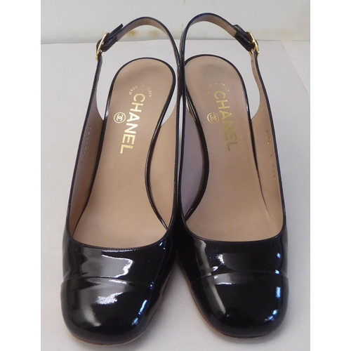 10 - A pair of ladies Chanel black leather heeled sling-backs  size 39 with a dust bag