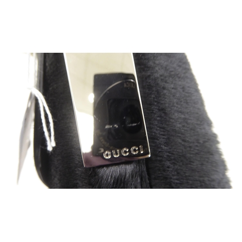 112 - A Gucci black fur covered handbag with a dust cover 