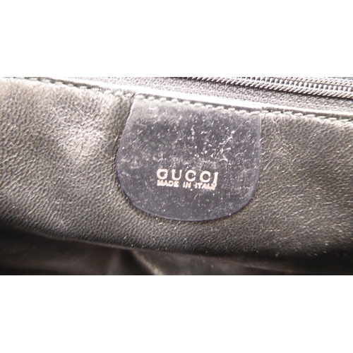 112 - A Gucci black fur covered handbag with a dust cover 