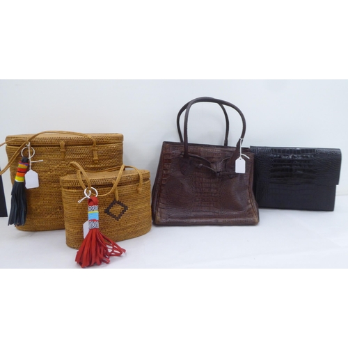 118 - Two raffia 1960s style bags; a Joan & David brown handbag; and a Krizia black clutch bag 