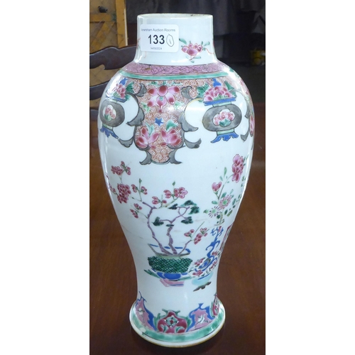 133 - A late 18thC Chinese porcelain vase of baluster form, decorated in floral and other designs  (drille... 