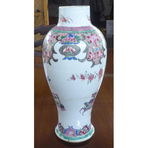 133 - A late 18thC Chinese porcelain vase of baluster form, decorated in floral and other designs  (drille... 