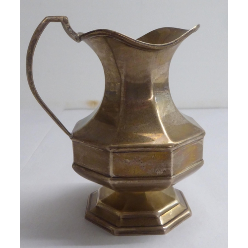 137 - Silver collectables: to include a milk jug of octagonal pedestal design  indistinct Birmingham ... 