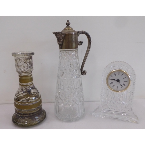 146 - Glassware: to include a cut crystal claret jug with a silver plated collar and lid  11