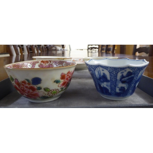 154 - 18thC and later Chinese porcelain items: to include a tea bowl and saucer, decorated with figures in... 