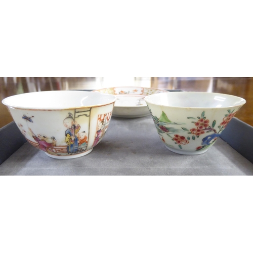 154 - 18thC and later Chinese porcelain items: to include a tea bowl and saucer, decorated with figures in... 