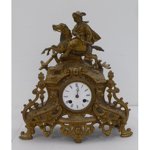 160 - An early/mid 20thC French gilded spelter mantel clock, fashioned as a cavalier on horseback; the mov... 