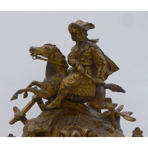 160 - An early/mid 20thC French gilded spelter mantel clock, fashioned as a cavalier on horseback; the mov... 