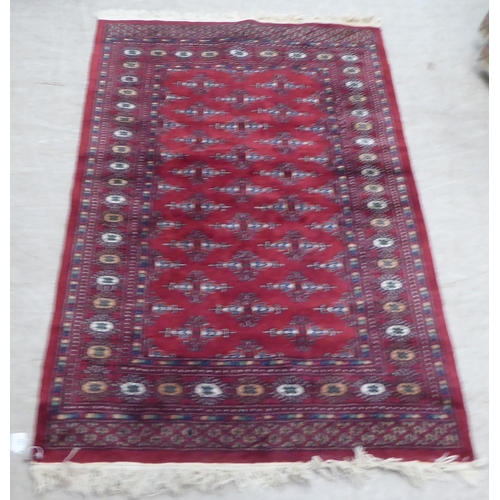 162 - A Persian rug, decorated with geometric motifs, on a red ground  63