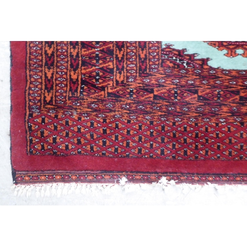 163 - A Persian rug, decorated with a central pole medallion, on a red ground  37