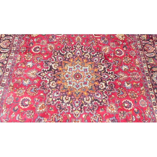 168 - An Iranian rug, decorated with ornate designs, on a red and blue ground  138