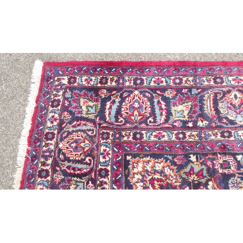 168 - An Iranian rug, decorated with ornate designs, on a red and blue ground  138