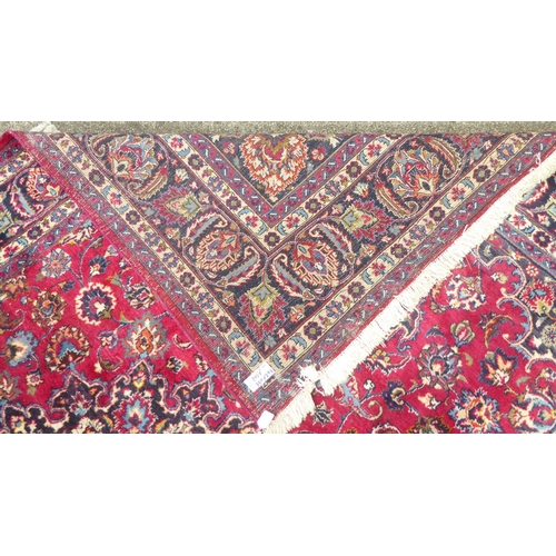 168 - An Iranian rug, decorated with ornate designs, on a red and blue ground  138