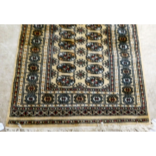 171 - A Bokhara rug, decorated with elephant foot motifs, on a beige and blue ground  60