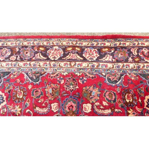 172 - A Persian rung, decorated with floral motifs, on red and blue  138