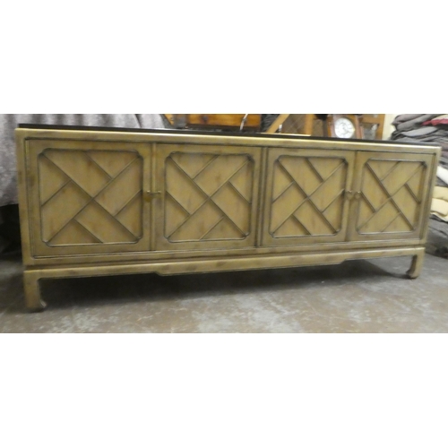 176 - A modern Chinese mahogany shabby chic finished sideboard with two pairs of panelled doors, raised on... 