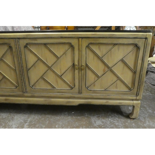 176 - A modern Chinese mahogany shabby chic finished sideboard with two pairs of panelled doors, raised on... 