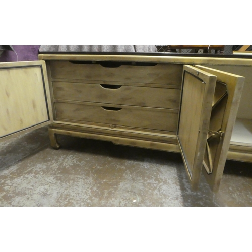 176 - A modern Chinese mahogany shabby chic finished sideboard with two pairs of panelled doors, raised on... 