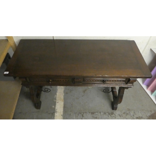 180 - A traditional Spanish style 19thC style oak two drawer serving table, raised on lyre shaped pierced ... 