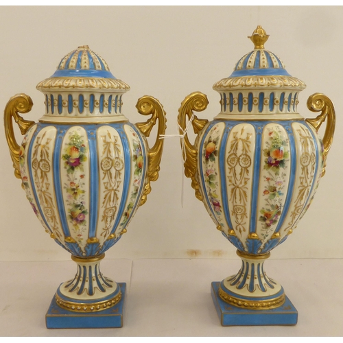 188 - A pair of late 19thC Rudolstadt porcelain vases of ovoid pedestal design, decorated with flowers and... 