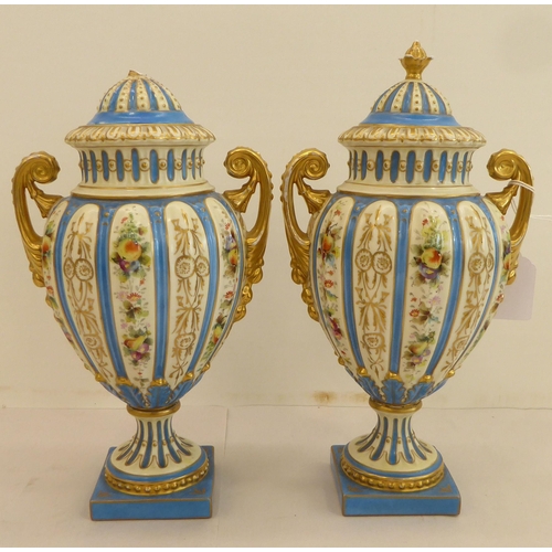 188 - A pair of late 19thC Rudolstadt porcelain vases of ovoid pedestal design, decorated with flowers and... 