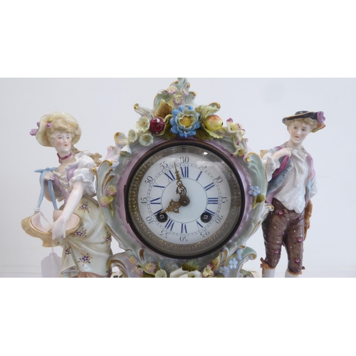 191 - A late 19thC Continental porcelain mantel clock, encrusted with flowers and fruit, surmounted by a m... 