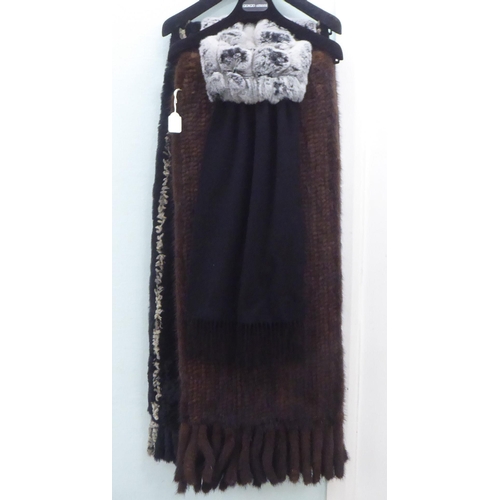 204 - Two fur wraps; and an N Peal black cashmere and fur stole 