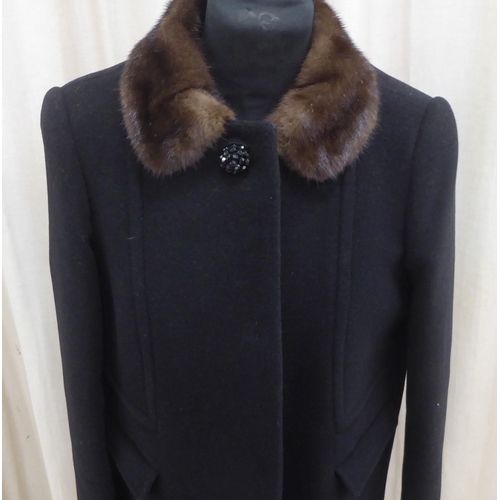 216 - A lady's Dolce & Gabbana mid-length black wool/cashmere coat with a detachable mink collar ... 