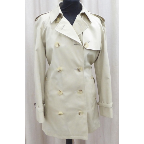 236 - A lady's Aquascutum cream coloured raincoat  size 8