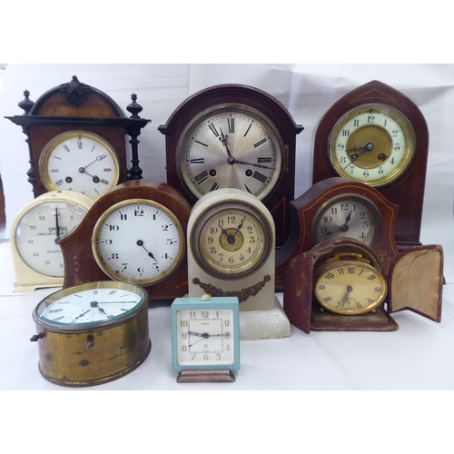 244 - Ten dissimilar early/mid 20thC clocks: to include an Edwardian string inlaid mahogany cased example ... 