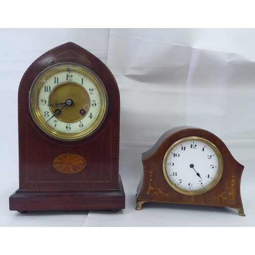 244 - Ten dissimilar early/mid 20thC clocks: to include an Edwardian string inlaid mahogany cased example ... 