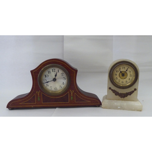 244 - Ten dissimilar early/mid 20thC clocks: to include an Edwardian string inlaid mahogany cased example ... 