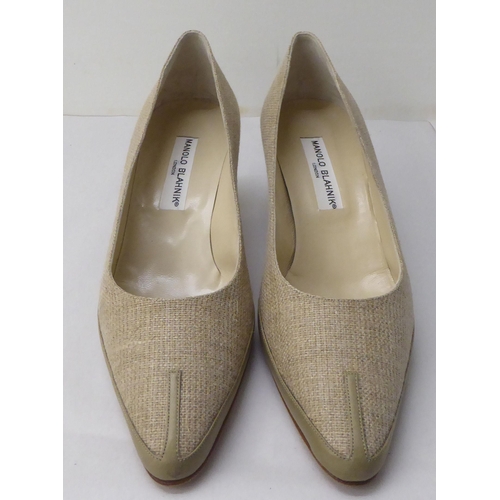 27 - A pair of ladies Manolo Blahnik fabric and leather bound, low heeled shoes  size 39 with a dust bag