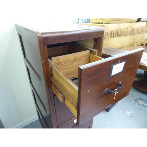 297 - A mid 20thC mahogany four drawer filing cabinet, on a plinth  52