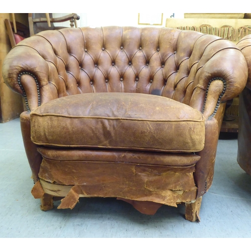 299 - A set of three early/mid 20thC stud and part button upholstered simulated brown hide armchairs, rais... 