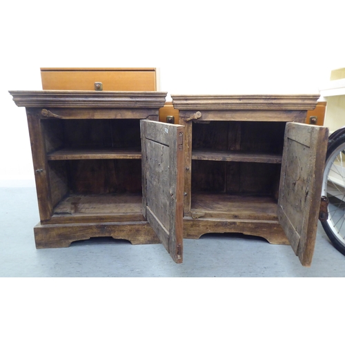 301 - Two similar rustically constructed hardwood single drawer bedside chests, on a bracket plinth  ... 