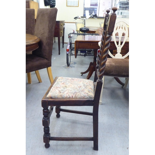 305 - Mainly early 20thC oak chairs: to include one with barleytwist uprights and a drop-in seat